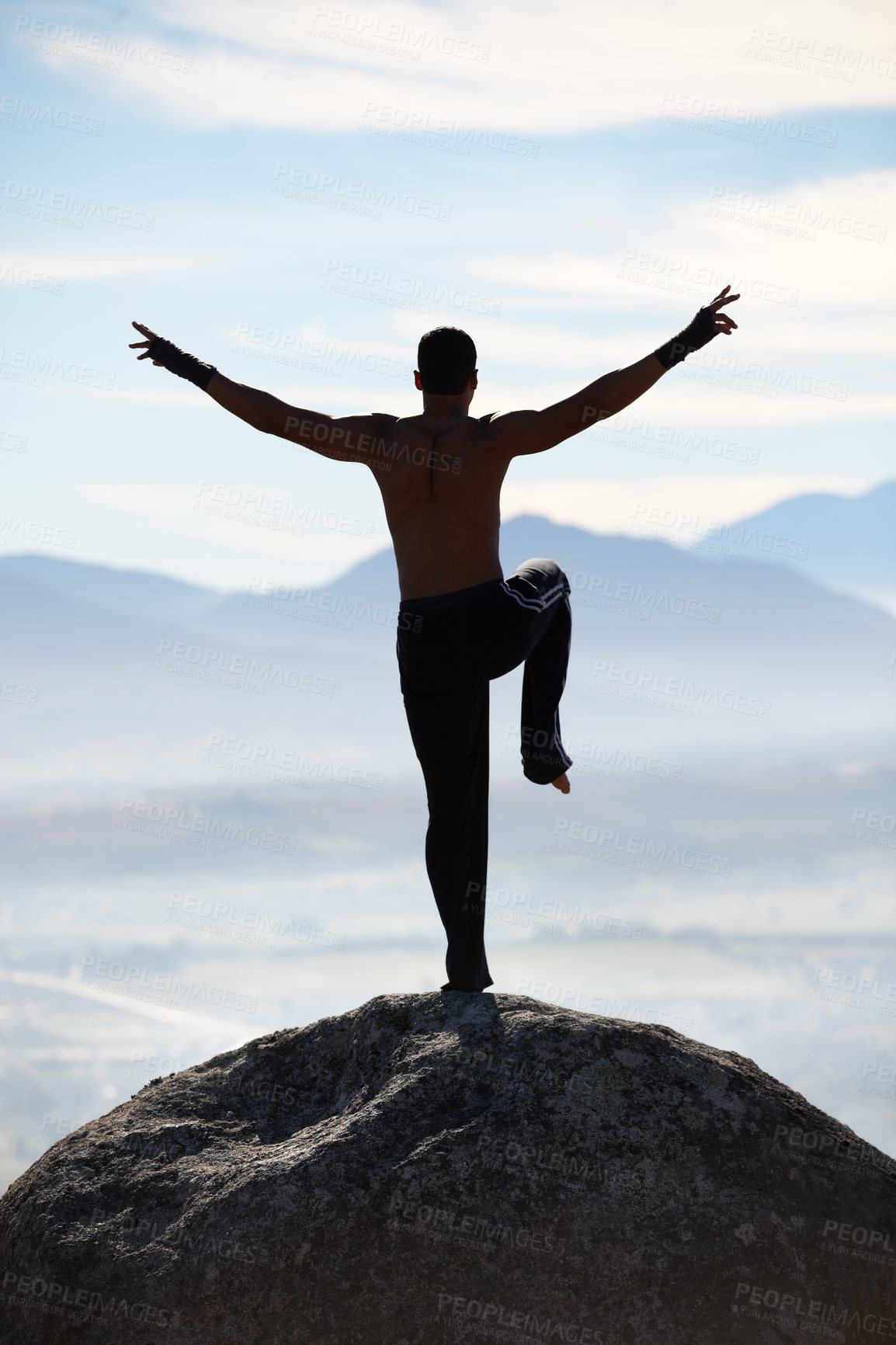 Buy stock photo Karate, balance and fitness man on mountain top for body training, power or workout on blue sky background. Martial arts, MMA and male taekwondo master in nature for exercise, sport or morning cardio