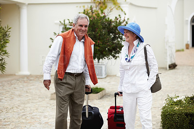 Buy stock photo Travel, vacation and senior couple walking with suitcase in a holiday location happy in retirement together by a hotel. Bag, smile and elderly people on a journey or man and woman walk in happiness