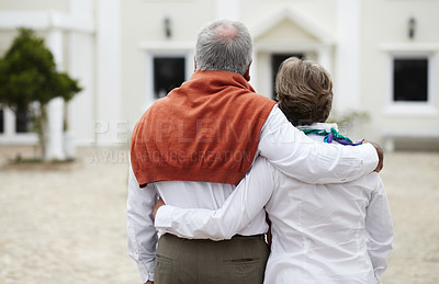 Buy stock photo Rear view of a senior couple embracing each other in the courtyard of their hotel