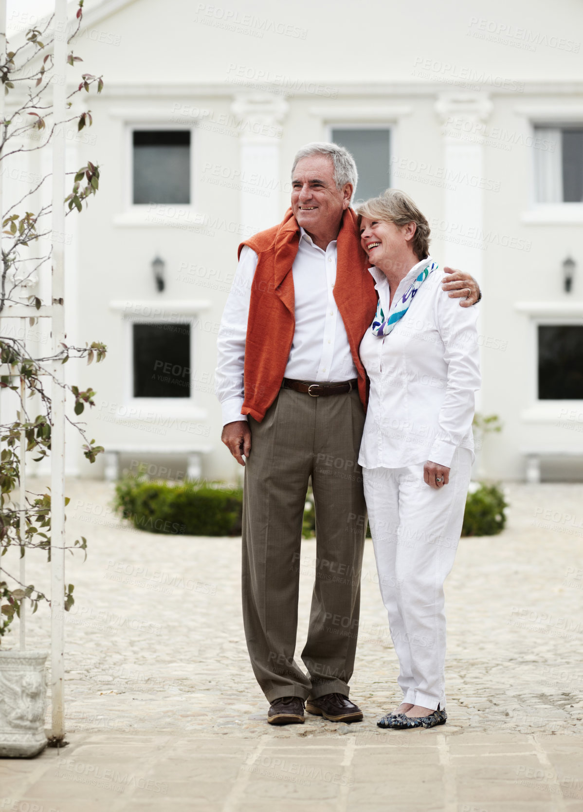 Buy stock photo Hug, smile and old couple outside hotel, villa and luxury hospitality on retirement vacation together. Marriage, travel and holiday accommodation, senior man and woman embrace in courtyard in Italy.
