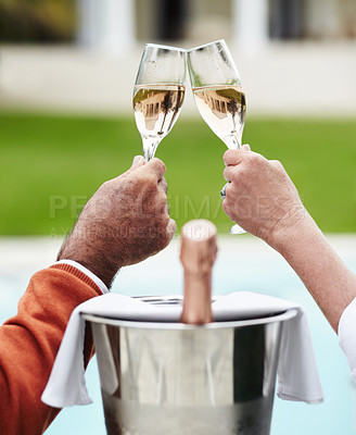Buy stock photo Champagne, toast and hands of senior couple at a hotel for travel, freedom or romantic adventure. Wine, cheers and elderly people with poolside celebration of retirement, success or anniversary