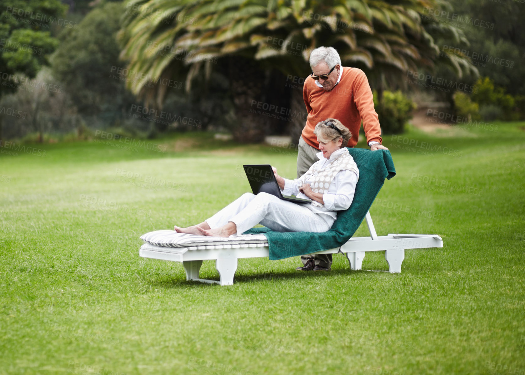 Buy stock photo Love, relax and senior couple with laptop in garden for internet, search or communication while bonding. Social media, computer and old people chilling in backyard with online streaming subscription