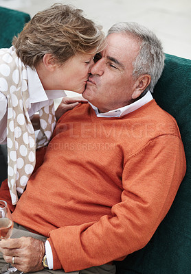 Buy stock photo Love, kiss and senior couple in a backyard with champagne for retirement, anniversary or celebration. Trust, gratitude and old people embrace in a yard with care, trust and bond, fun and romance