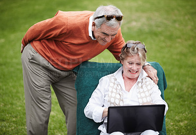 Buy stock photo Love, laptop and an old couple in the garden of a hotel for travel or vacation at a luxury resort. Retirement, technology or social media with a senior man and woman tourist on the grass at a lodge