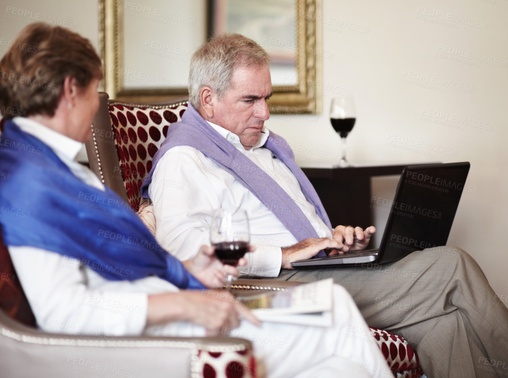 Buy stock photo Senior couple, laptop and typing on sofa in relax with wine for holiday, trip or reservation at hotel. Mature man working on laptop with woman enjoying accommodation service or lounge suite at resort
