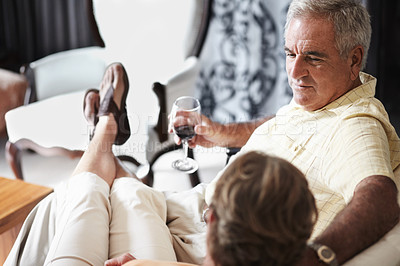 Buy stock photo Relax, love and an old couple drinking wine in their hotel room while on holiday or vacation together. Toast, sofa or retirement with a senior man and woman bonding at a luxury resort for romance