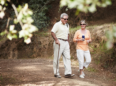 Buy stock photo A senior couple out for a walk in the forest together