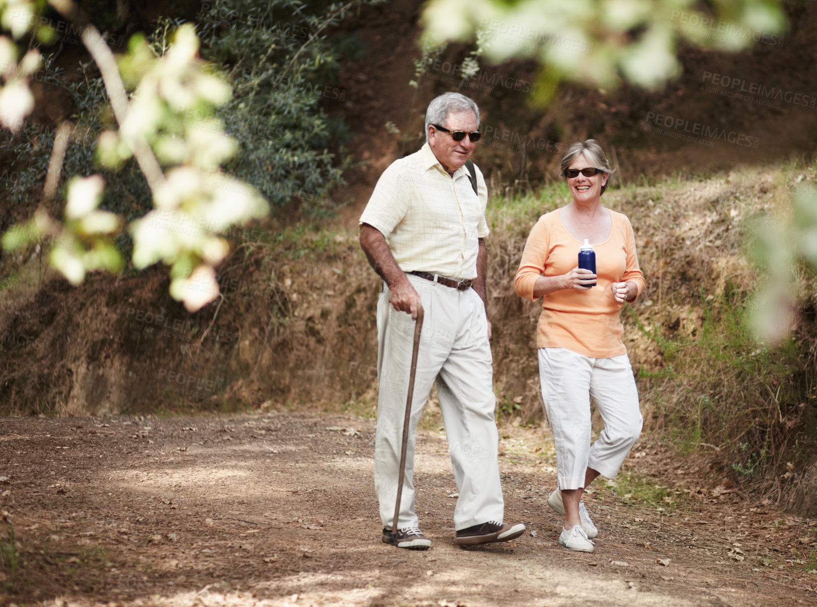 Buy stock photo A senior couple out for a walk in the forest together