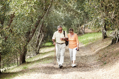 Buy stock photo Hiking, fitness and senior couple in forest walking for retirement exercise, wellness support and path in nature. Elderly people in woods for cardio, travel and carbon footprint journey or trekking