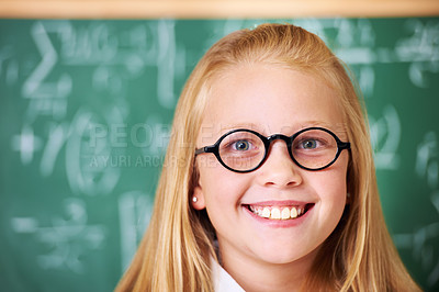 Buy stock photo Portrait of student, nerd and happy child by chalkboard in class for learning knowledge, education and study math. Face, glasses and smile of geek at school, girl or cute kid in classroom in Canada