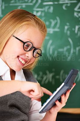 Buy stock photo child, girl and calculator by chalkboard for happy education, learning and problem solving or solution. Smart student or child with glasses and excited for school, typing numbers or math in classroom