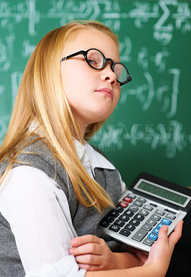 Buy stock photo GIrl, portrait and calculator by chalkboard for education, learning and problem solving or solution with confidence. Smart kid, student or child with glasses for school, numbers and math in classroom