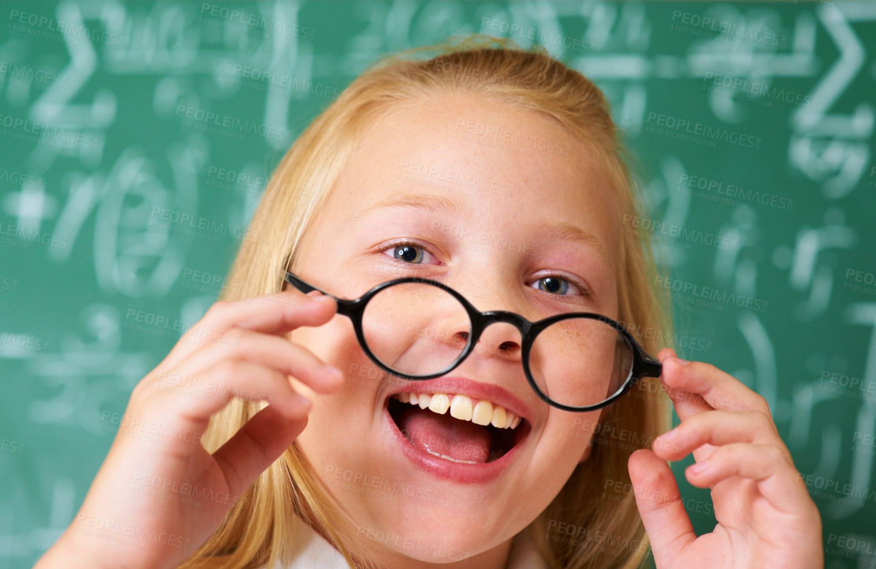 Buy stock photo Excited, smile and portrait of child student in classroom with glasses by board for lesson or studying. Education, learning and happy young girl kid with positive attitude for scholarship in school.