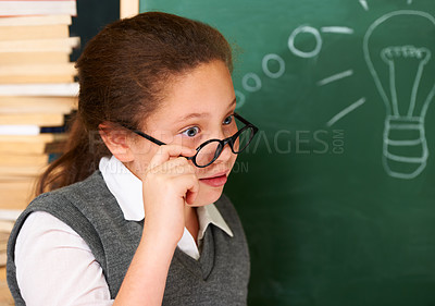 Buy stock photo Shock, idea and student with light bulb on board for planning, decision or brainstorming in classroom. Education, learning and surprised girl child with drawing for choice, vision or future in school