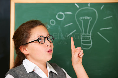 Buy stock photo Student, girl and lightbulb for solution on chalkboard, learning and wow, surprise and knowledge or school ideas. child or kid thinking with light bulb, classroom education and doodle for vision