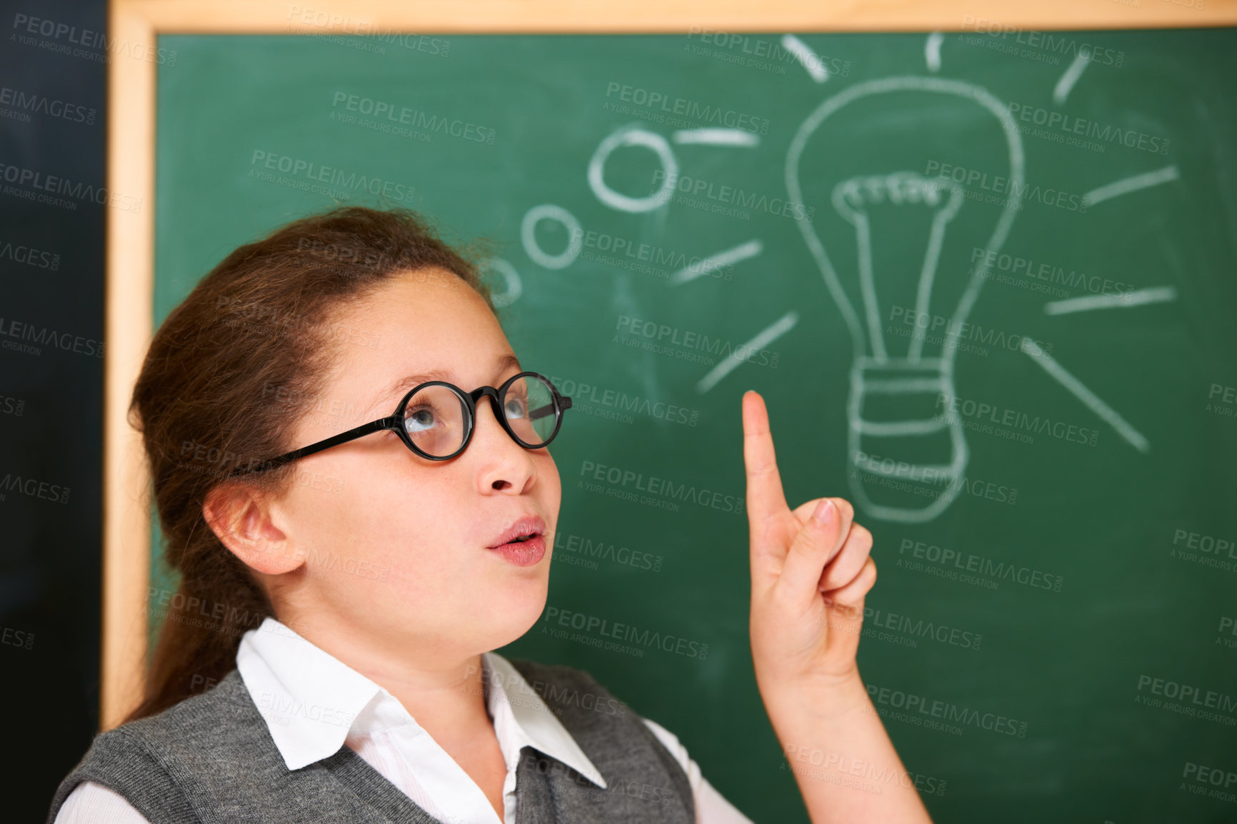 Buy stock photo Student, girl and lightbulb for solution on chalkboard, learning and wow, surprise and knowledge or school ideas. child or kid thinking with light bulb, classroom education and doodle for vision