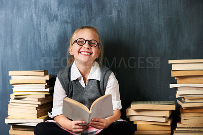 Buy stock photo Girl, chalkboard and child reading book for education, language learning and knowledge in classroom. Kid or student on floor with books, glasses and happy for school, English and literature portrait