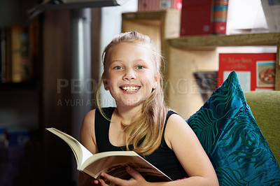 Buy stock photo Portrait of a cute blonde girl relaxed and reading on the sofa