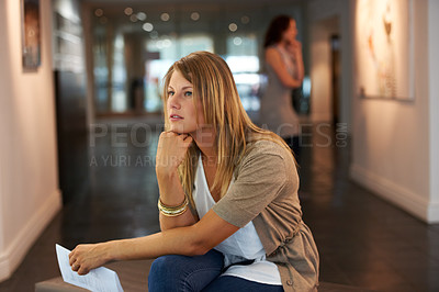 Buy stock photo Museum, exhibition and a woman thinking in a painting gallery while looking at photography in creative appreciation. Art, design and culture with an attractive young female at an artwork expo exhibit