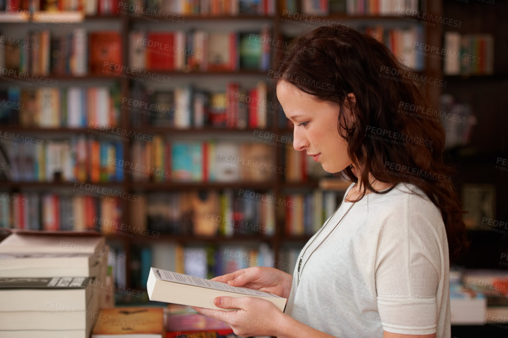 Buy stock photo Woman, bookstore and reading with sale, choice and thinking for decision, learning or ideas. Girl, novel or literature in store, library or college for deal, discount or retail shopping for knowledge