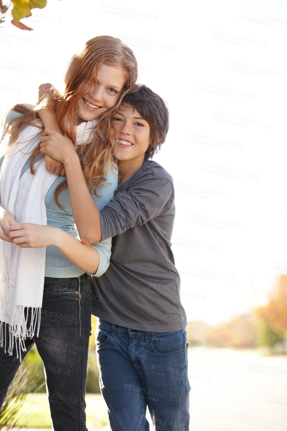 Buy stock photo Love, portrait of brother with sister and hug outdoors for support with a lens flare with smile. Care or bonding time, family and happy people hugging outside together for health wellness in nature