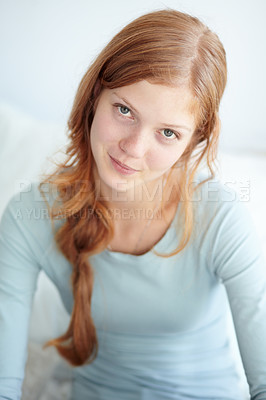 Buy stock photo Portrait of a young girl sitting on her bed