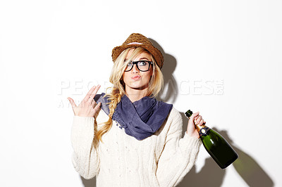 Buy stock photo Woman, blonde and hat with champagne of nerd, geek or hipster thinking against a studio background. Attractive female person with glasses, nerdy or fashion style gesture and holding bottle of alcohol