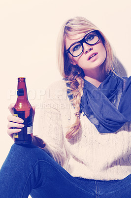 Buy stock photo Portrait, fashion and drinking beer with a woman in studio on a white wall background to relax. Glasses, scarf and glass bottle with a beverage in the hand of a young person for winter celebration