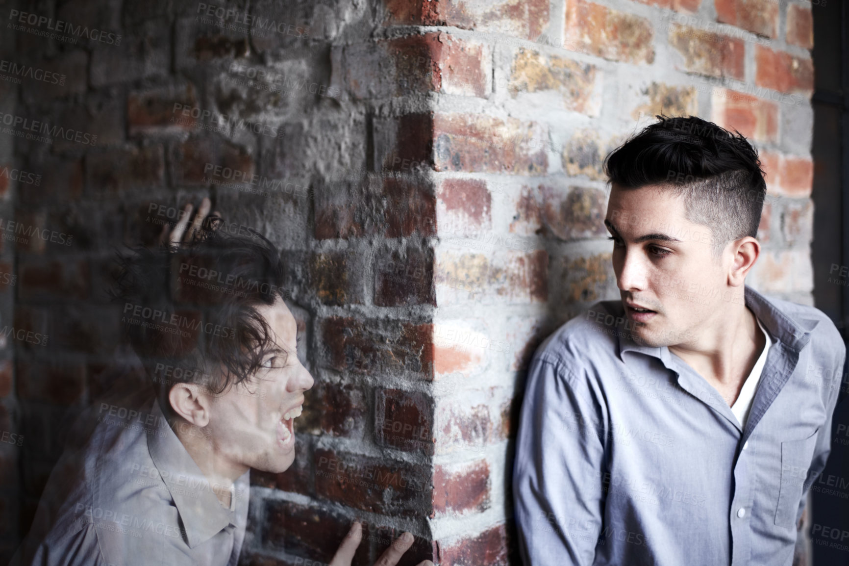 Buy stock photo Man, fear and hide by brick wall with schizophrenia, mental health and panic for ghost or haunted soul. Person, scared or anxiety for character, illusion or paranoid expression and psychological risk