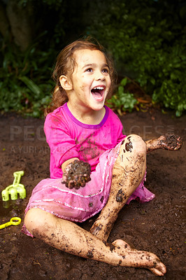 Buy stock photo Shot of a little girl playing outside in the mud