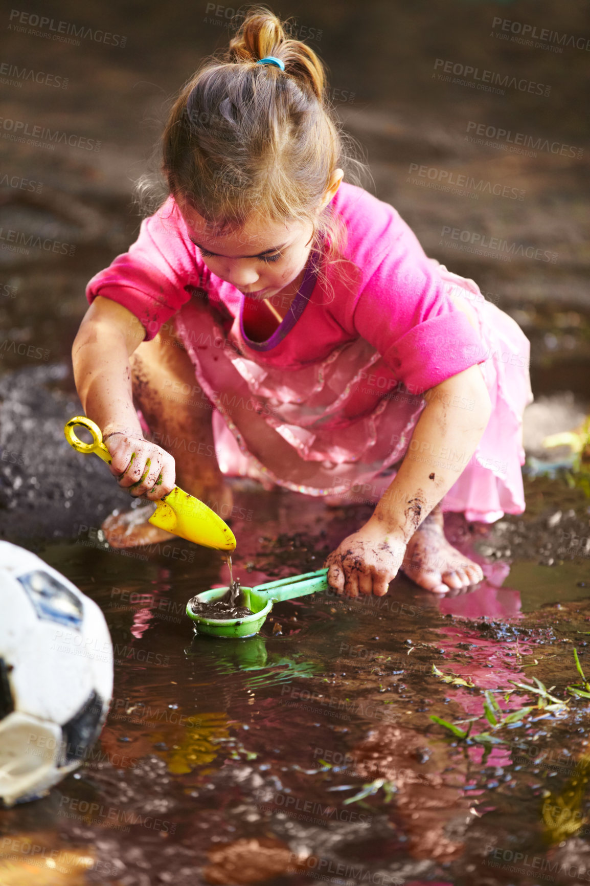 Buy stock photo Girl, child and play with toys in mud for freedom, activity and muddy fun in sunshine weather or outdoor. Kid, female and river of person with peace for playing, enjoyment and relax in dirt water