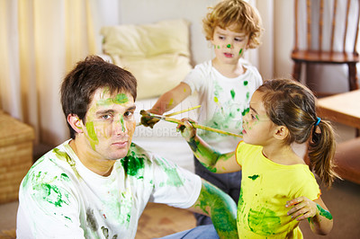 Buy stock photo Shot of a dad being painted by his children