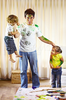 Buy stock photo Family, paint and messy children on dad, childhood and crazy in living room at home, bad and naughty. Father and kids, painting and art on clothing, energy and punishment for behavior by tired man