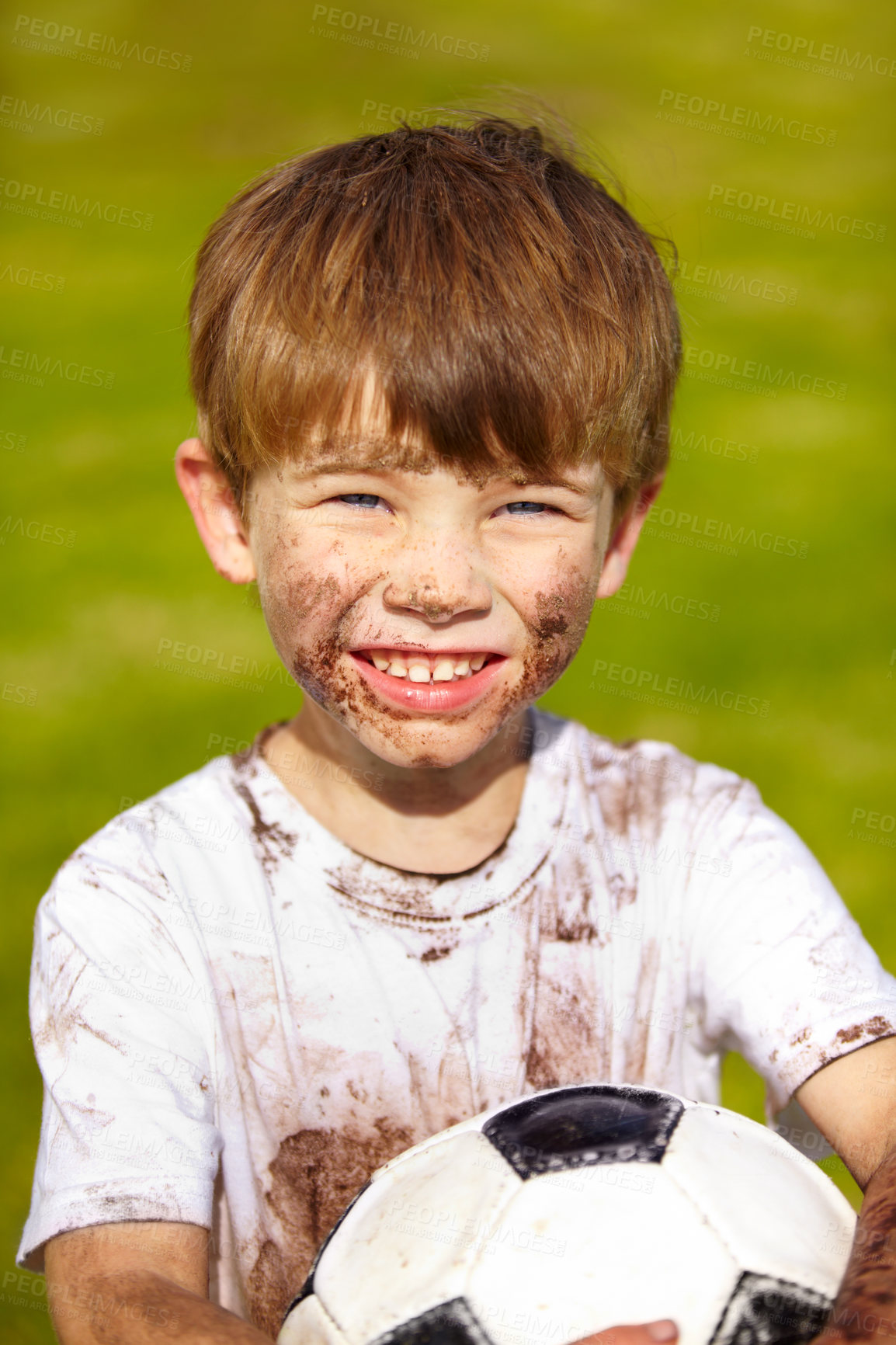 Buy stock photo Portrait of a muddy little boy holding a soccer ball