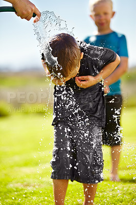 Buy stock photo Children, boys and hose pipe with water fun, splash and playing outdoor in backyard or garden for sunshine. Kids, brother and people on grass or lawn with happiness, activity and enjoyment in summer