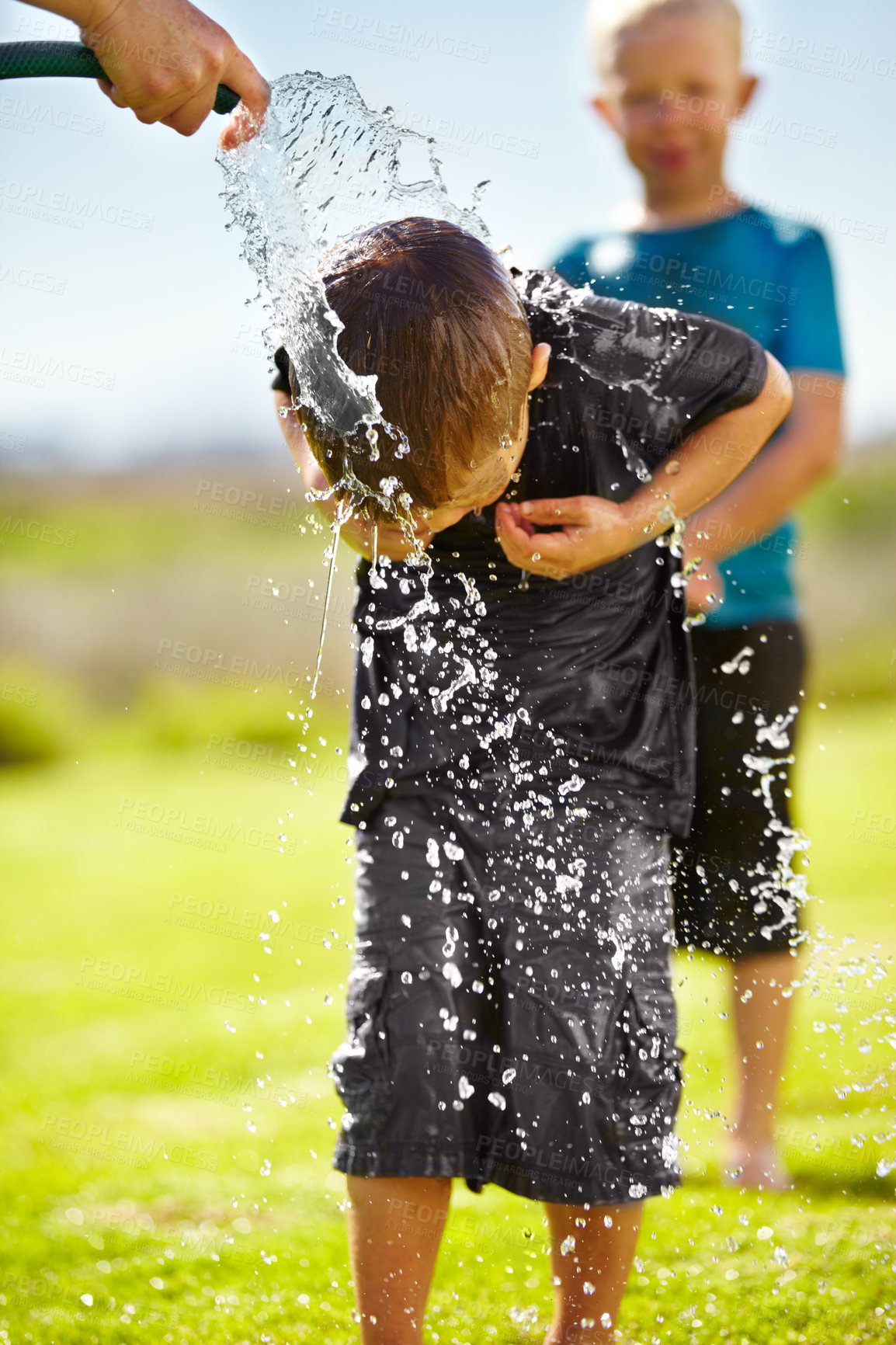 Buy stock photo Children, boys and hose pipe with water fun, splash and playing outdoor in backyard or garden for sunshine. Kids, brother and people on grass or lawn with happiness, activity and enjoyment in summer