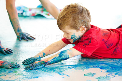 Buy stock photo Cute little boys using fingerpaint on the floor