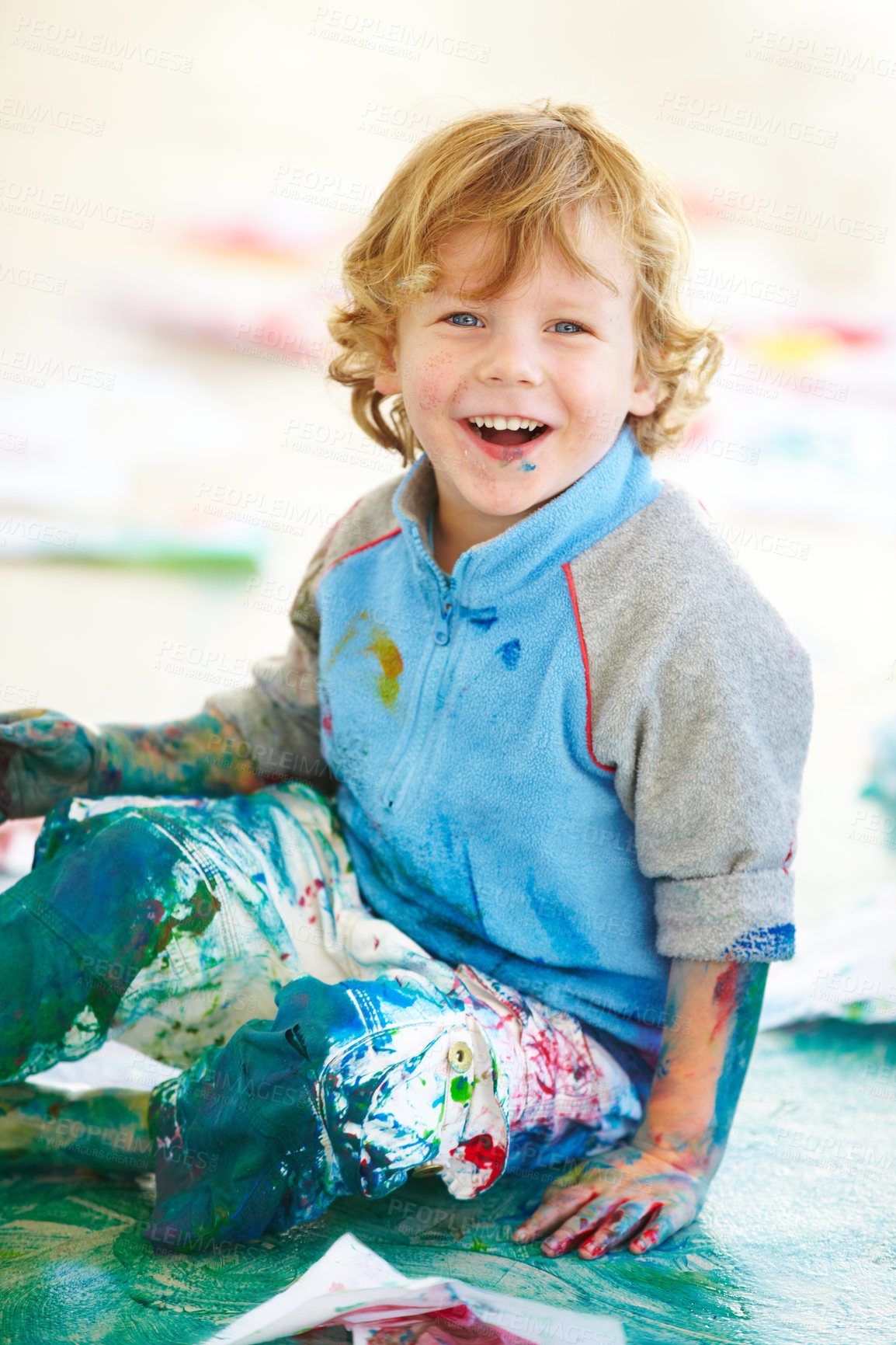 Buy stock photo Portrait, art and a boy painting on the floor of a studio for creative expression or education at school. Smile, paint and an excited young child looking happy with his messy artistic creativity
