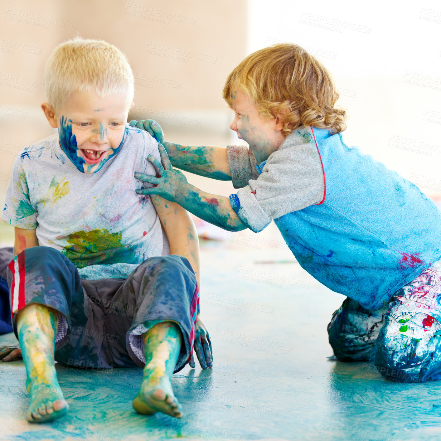 Buy stock photo Friends, smile and children painting on the floor of a studio for creative expression or education at school. Art, paint and excited young boys looking happy with their messy artistic creativity