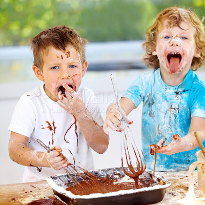 Buy stock photo Shot of two messy little boys trying to make a cake