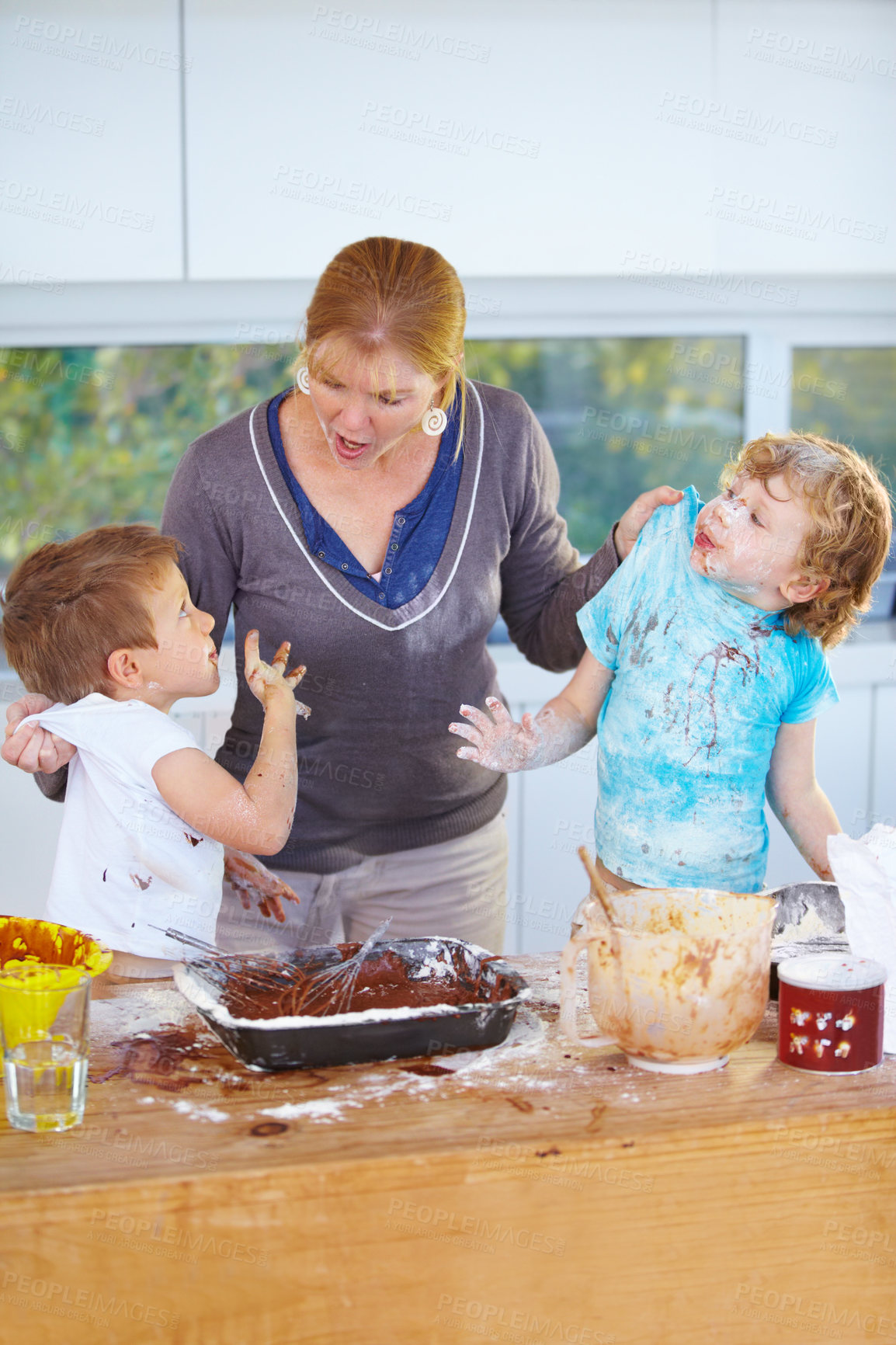 Buy stock photo Family, baking and a mother scolding her children for the mess in a home kitchen with naughty boys. Food, cake or ingredients with a woman yelling at her kids while cooking in an untidy apartment