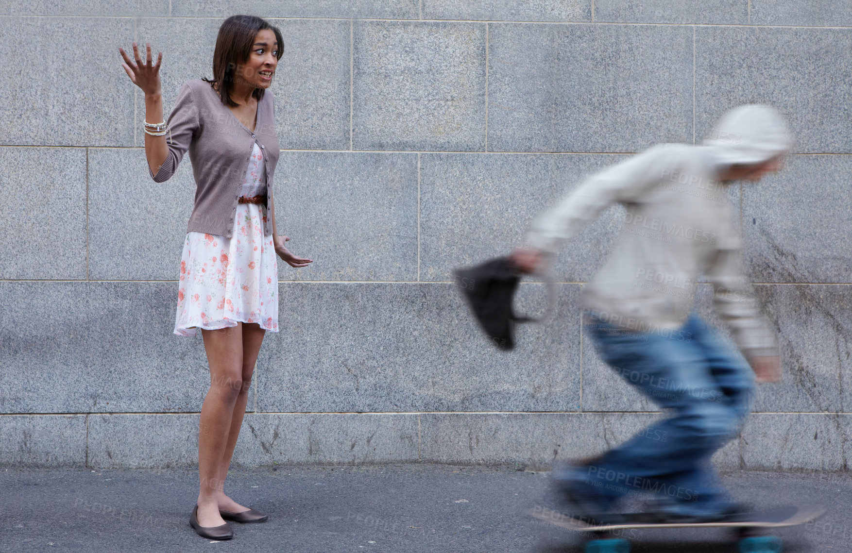 Buy stock photo Young woman having her bag snatched by a criminal on a skateboard