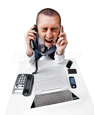 Buy stock photo A frustrated young man trying to answer multiple phones and feeling stressed