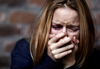 Buy stock photo Abused young woman crying hard and covering her mouth