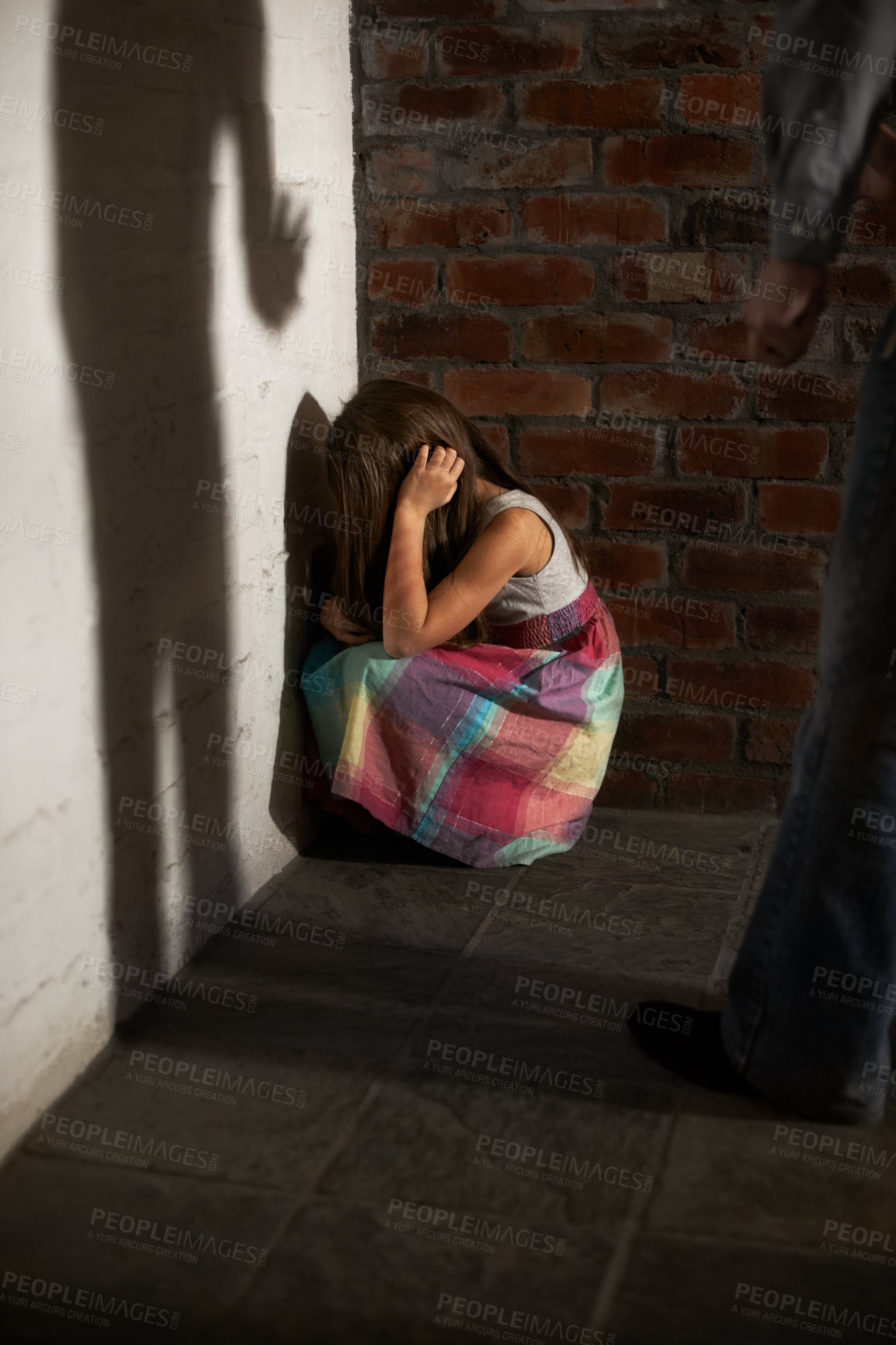 Buy stock photo Scared, man and woman with domestic violence, abuse and anxiety in a corner, problem and depression. People, couple or home with stress, crime and fear with anger, fighting and terror in a lounge