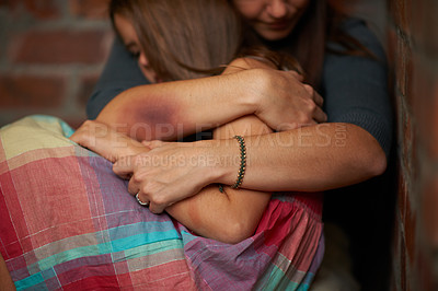 Buy stock photo Abused woman embracing her frightened daughter