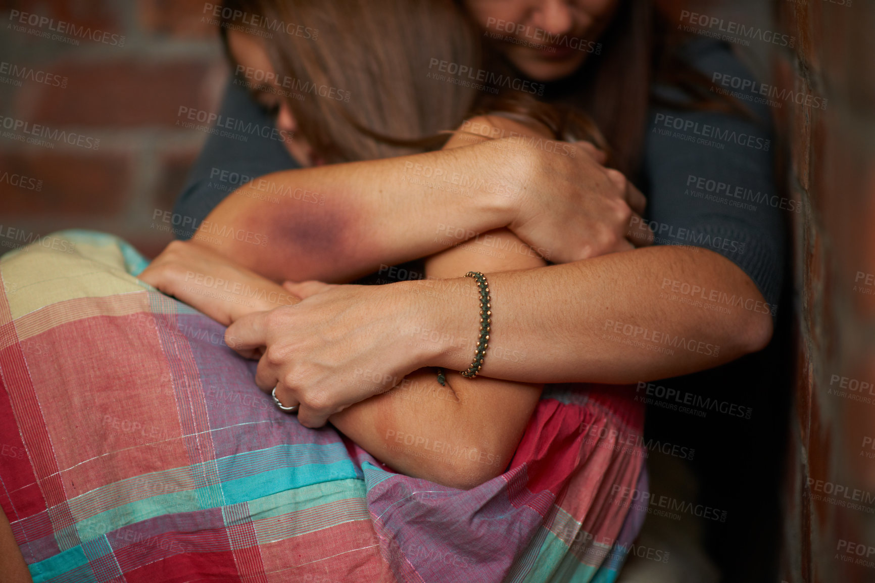 Buy stock photo Abused woman embracing her frightened daughter