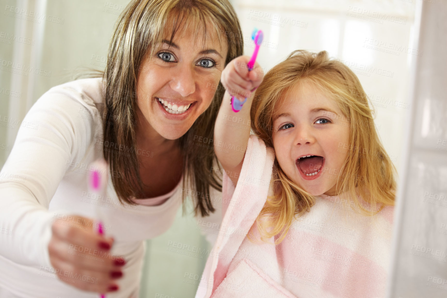 Buy stock photo Cute little girl getting ready to brush her teeth with her mom