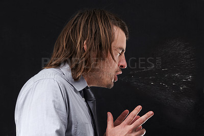 Buy stock photo Profile view of a young businessman sneezing