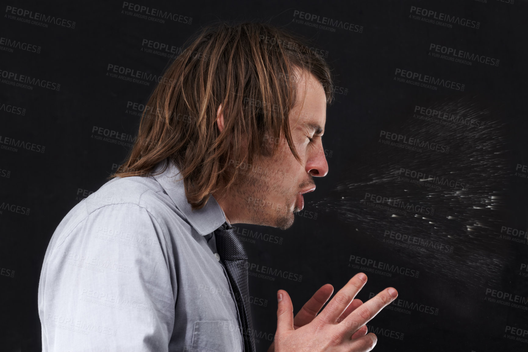 Buy stock photo Profile view of a young businessman sneezing